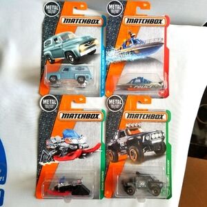 4 Matchbox 1:64 Scale Vehicles. Truck,Boat,Snowmobile and Off Road Truck.Unopen